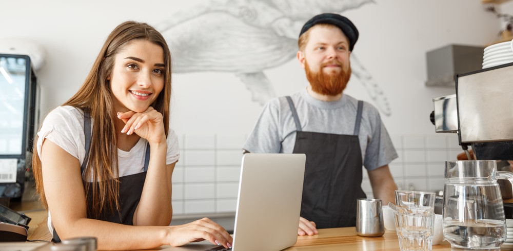 Cheerful baristas placing online orders