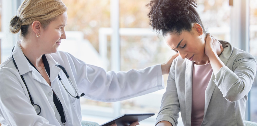 Doctor consulting woman with neck pain