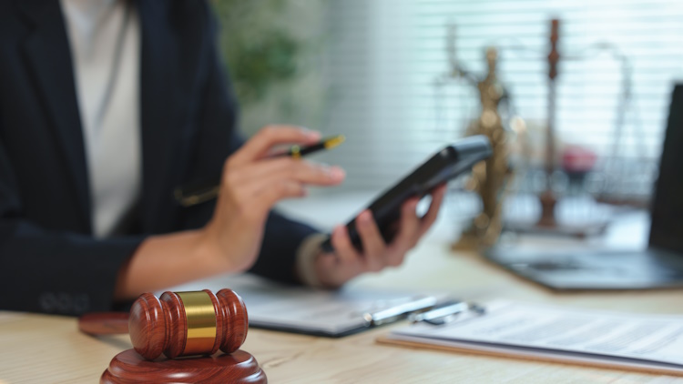 Female lawyer calculating damages