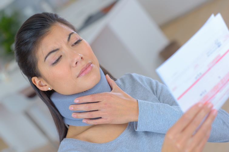 woman with neck braces reading the medical bill woman with neck braces reading the medical bill