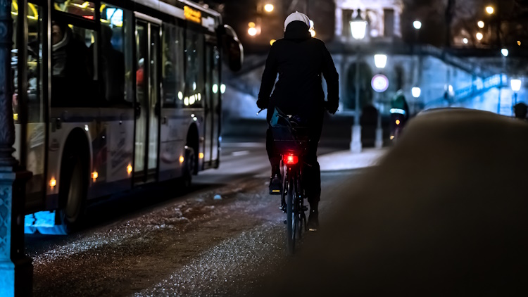 cyclist riding safe with helmet and bike lights