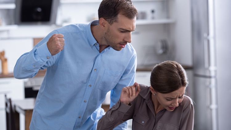 aggressive man beating scared wife