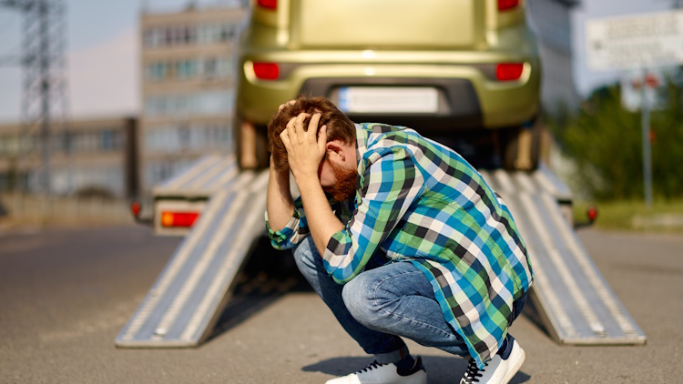 Frustrated man having his car towed Frustrated man having his car towed