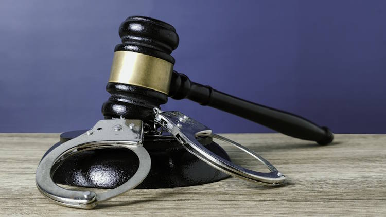 Judge's Gavel and Handcuffs Symbolizing Criminal Justice