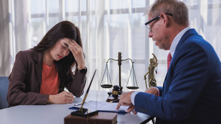 Distressed woman meeting attorney for legal advice