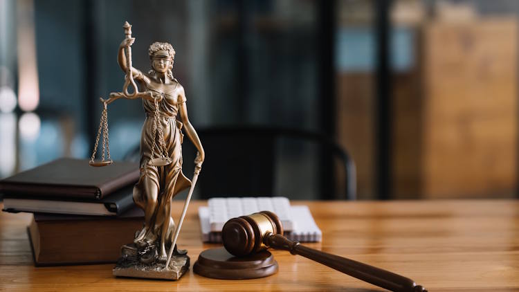 Statue of lady justice on desk of a judge